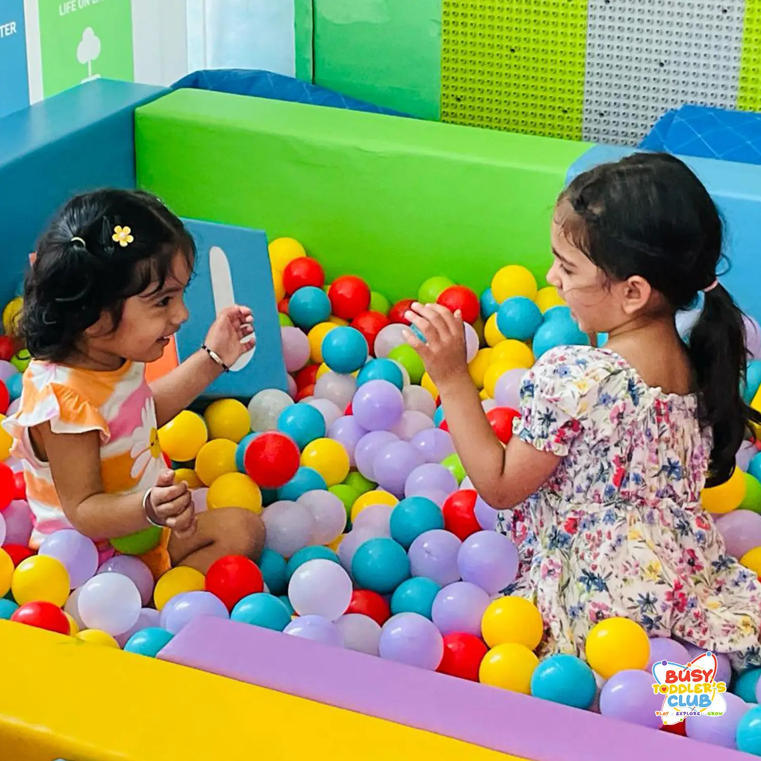 Children enjoying a colourful soft play ball pool